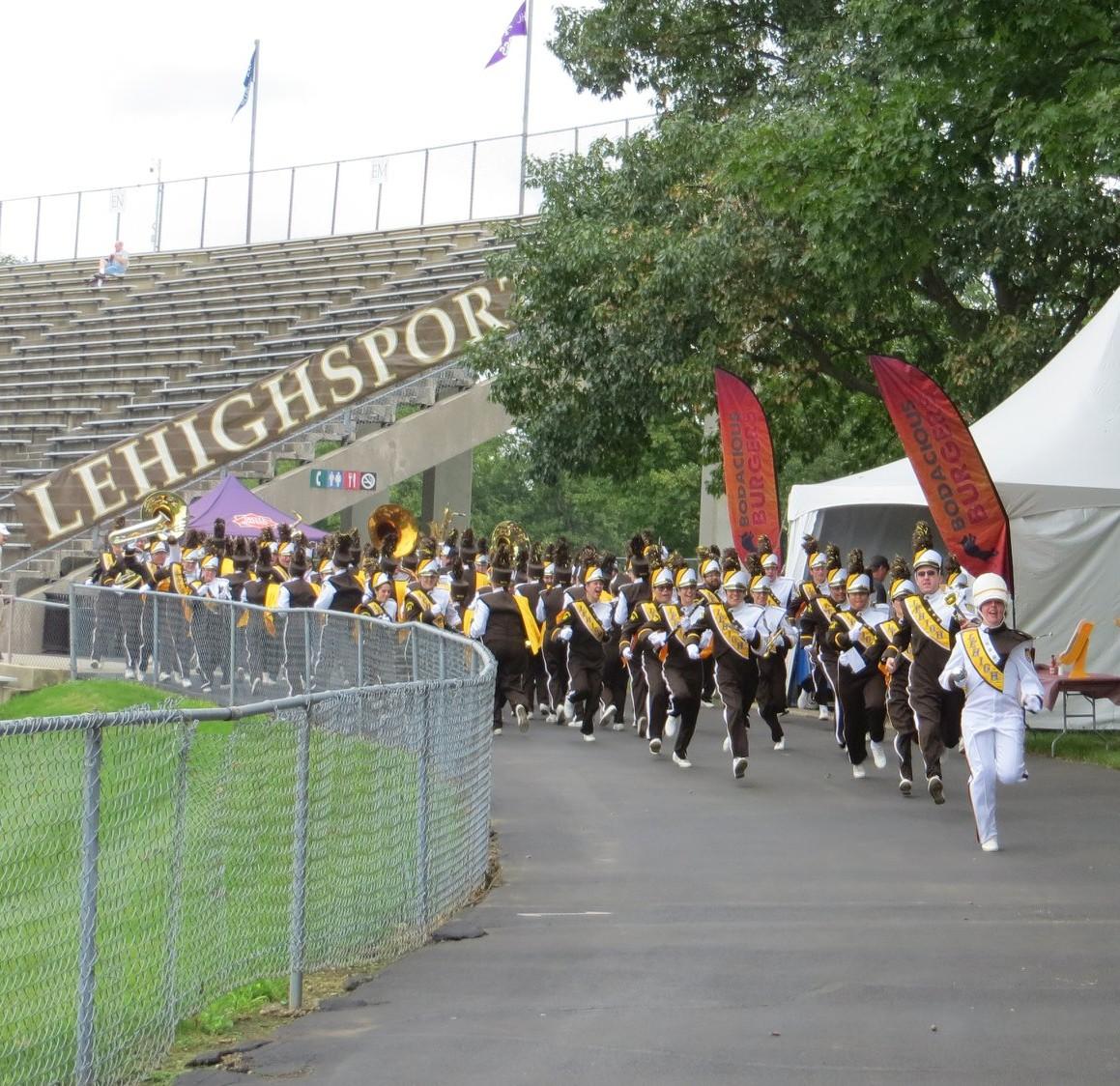 The Marching 97 running from one end of the stadium to the other during the psyche run