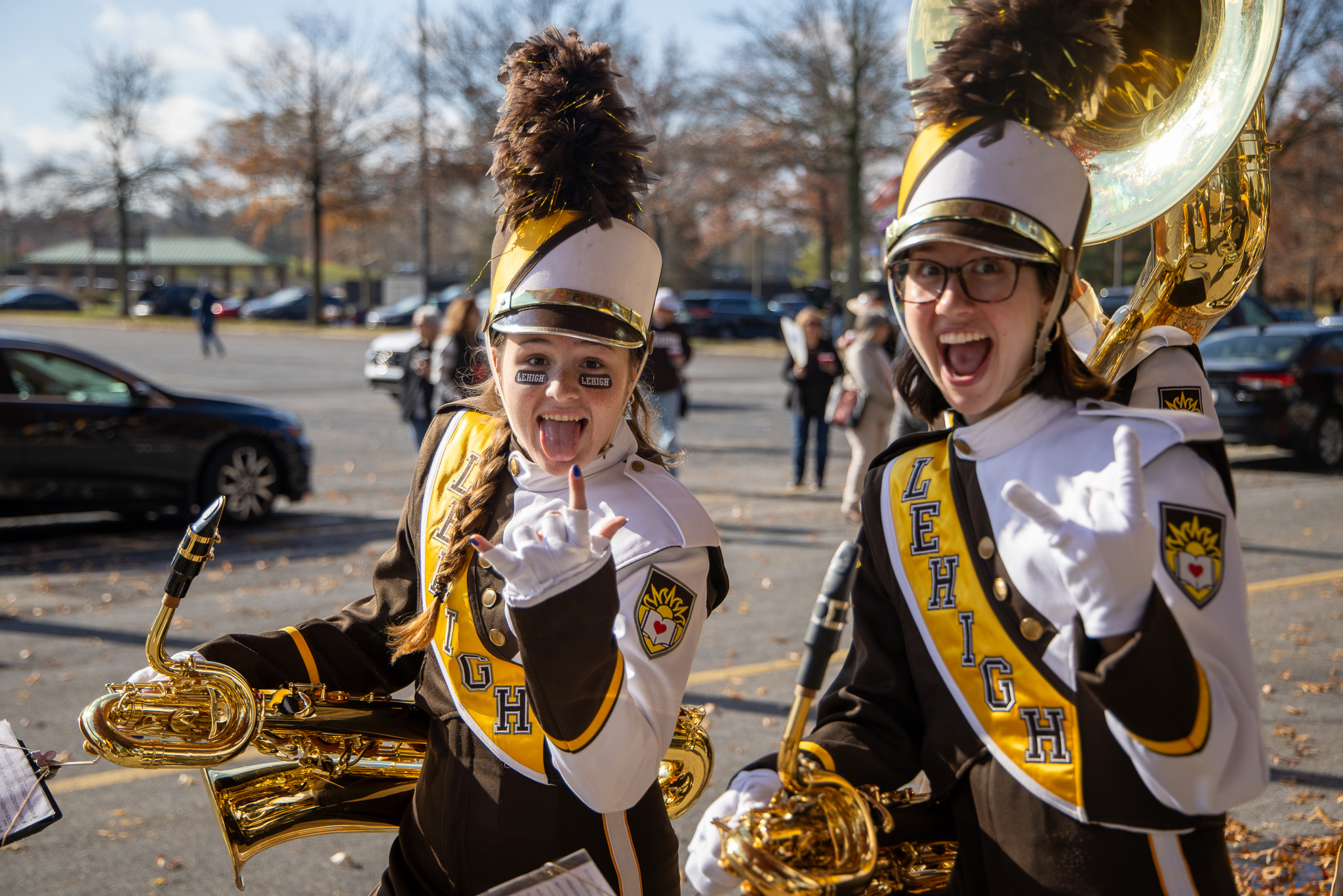 2 baritone saxophonists posing during tailgating