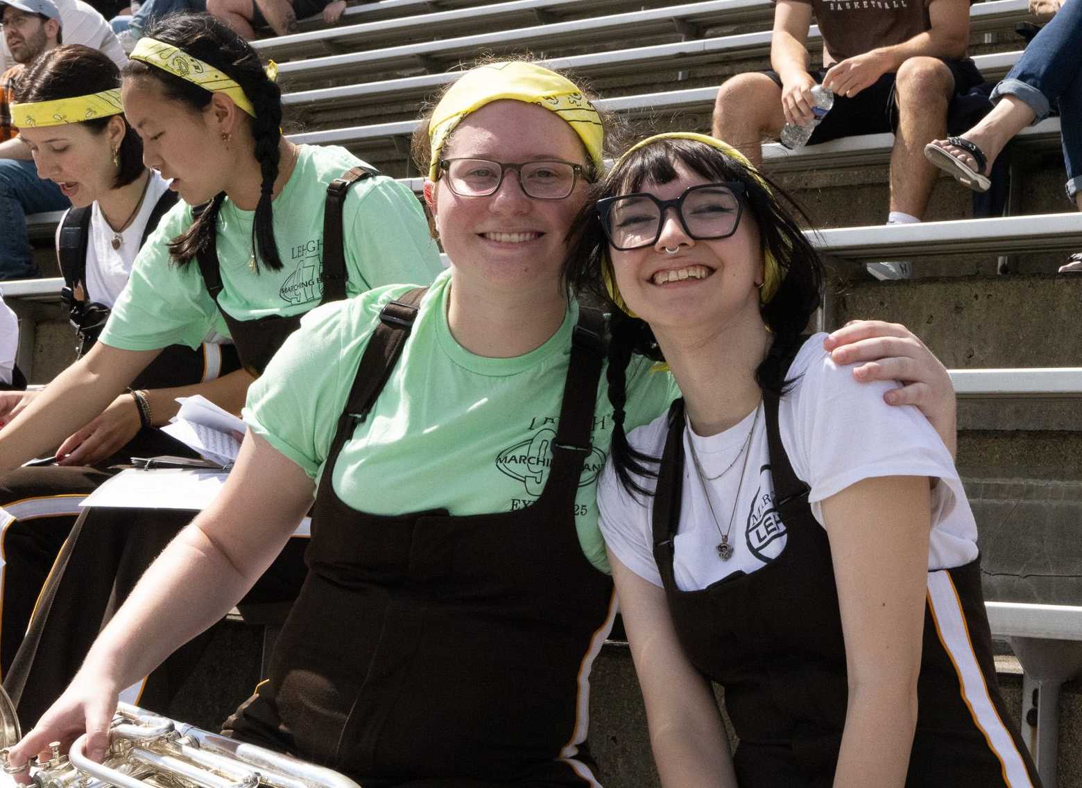 Two baritone players smiling together the stands
