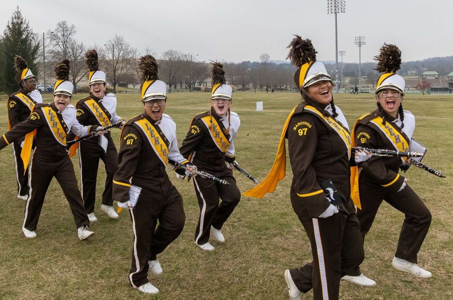 Clarinet players cheering and posing while tailgating