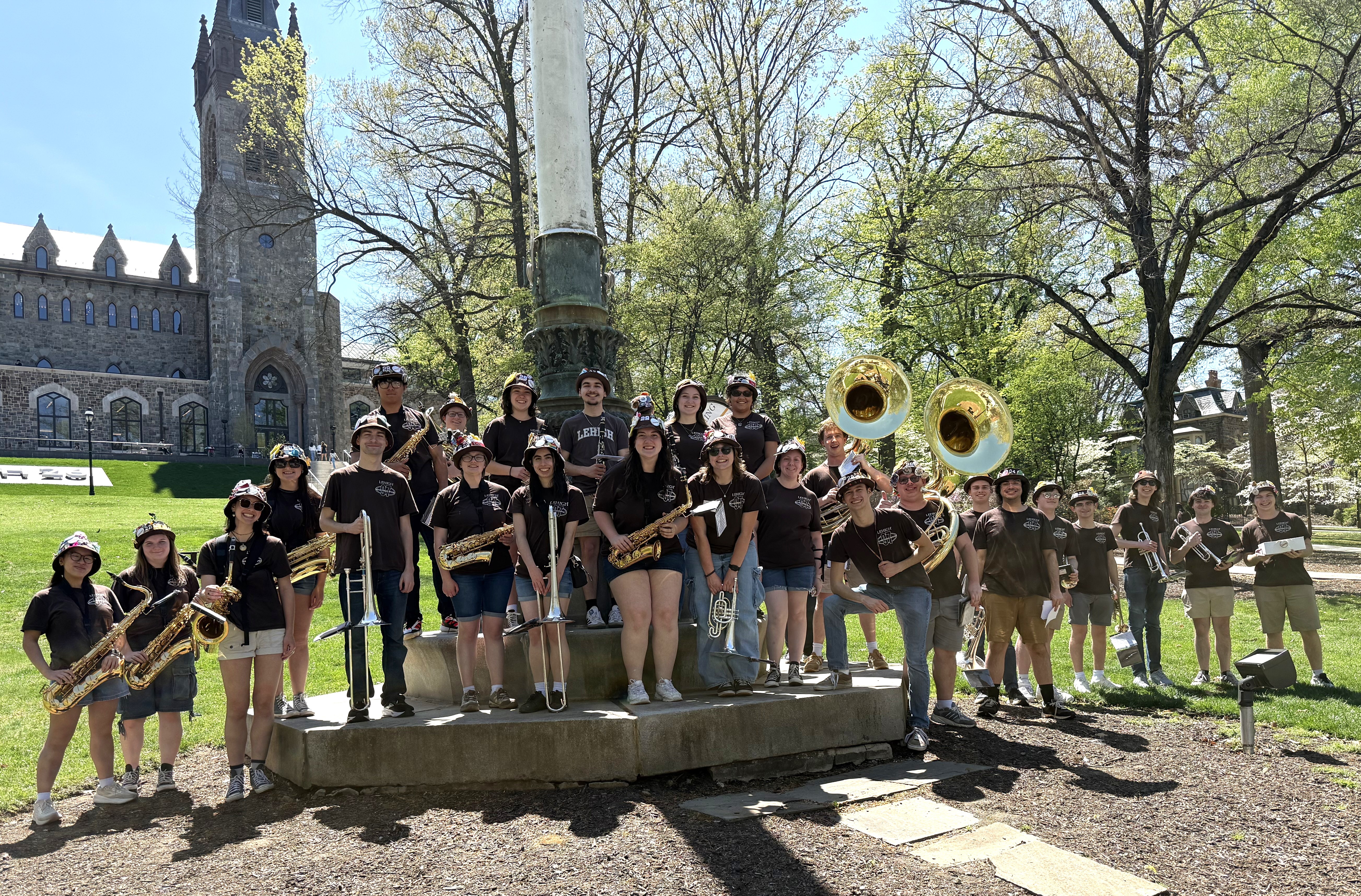 The band smiling in front of the University Center flagpole during Lehigh Fest