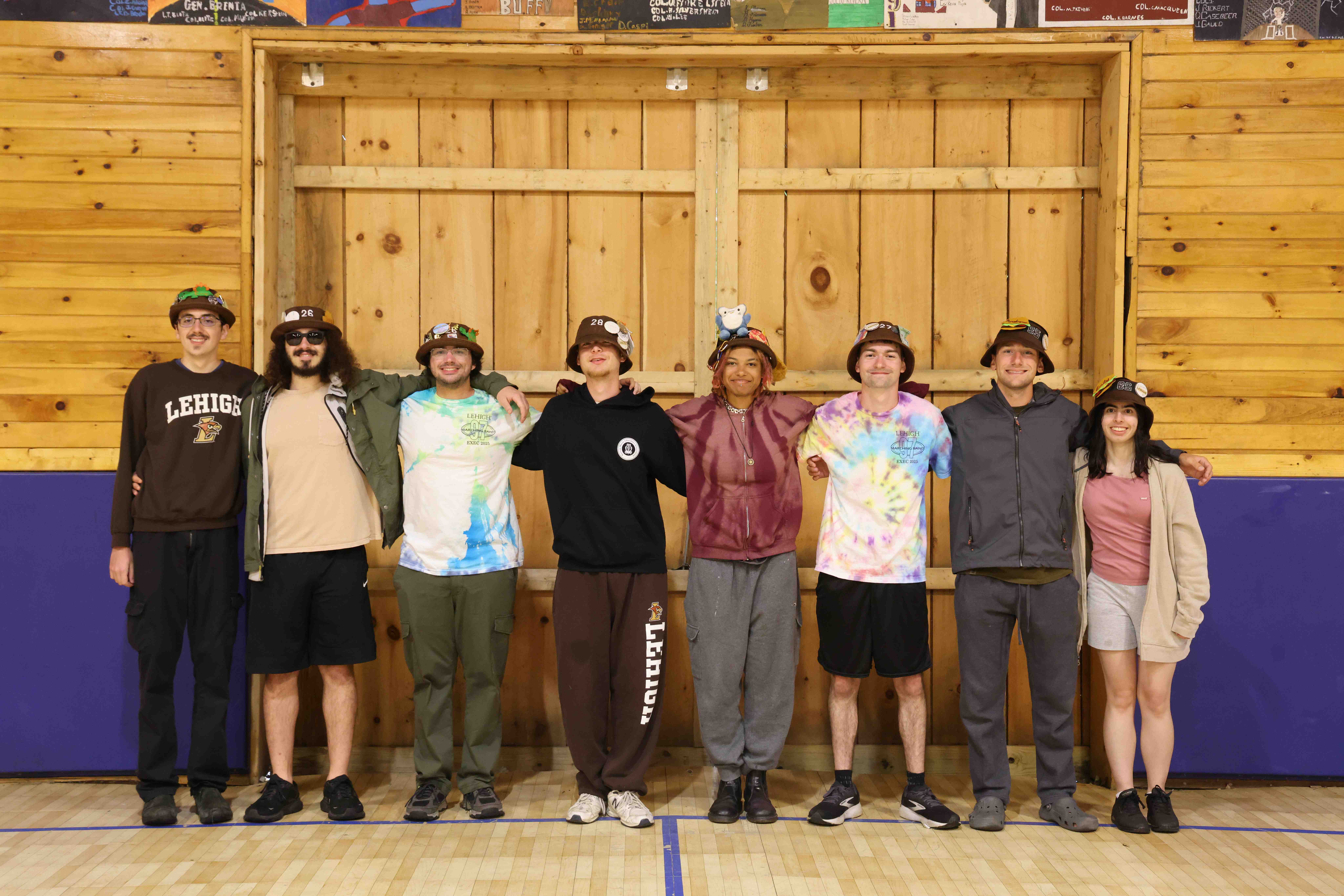 Rank 1 smiling with their arms around each other at band camp.