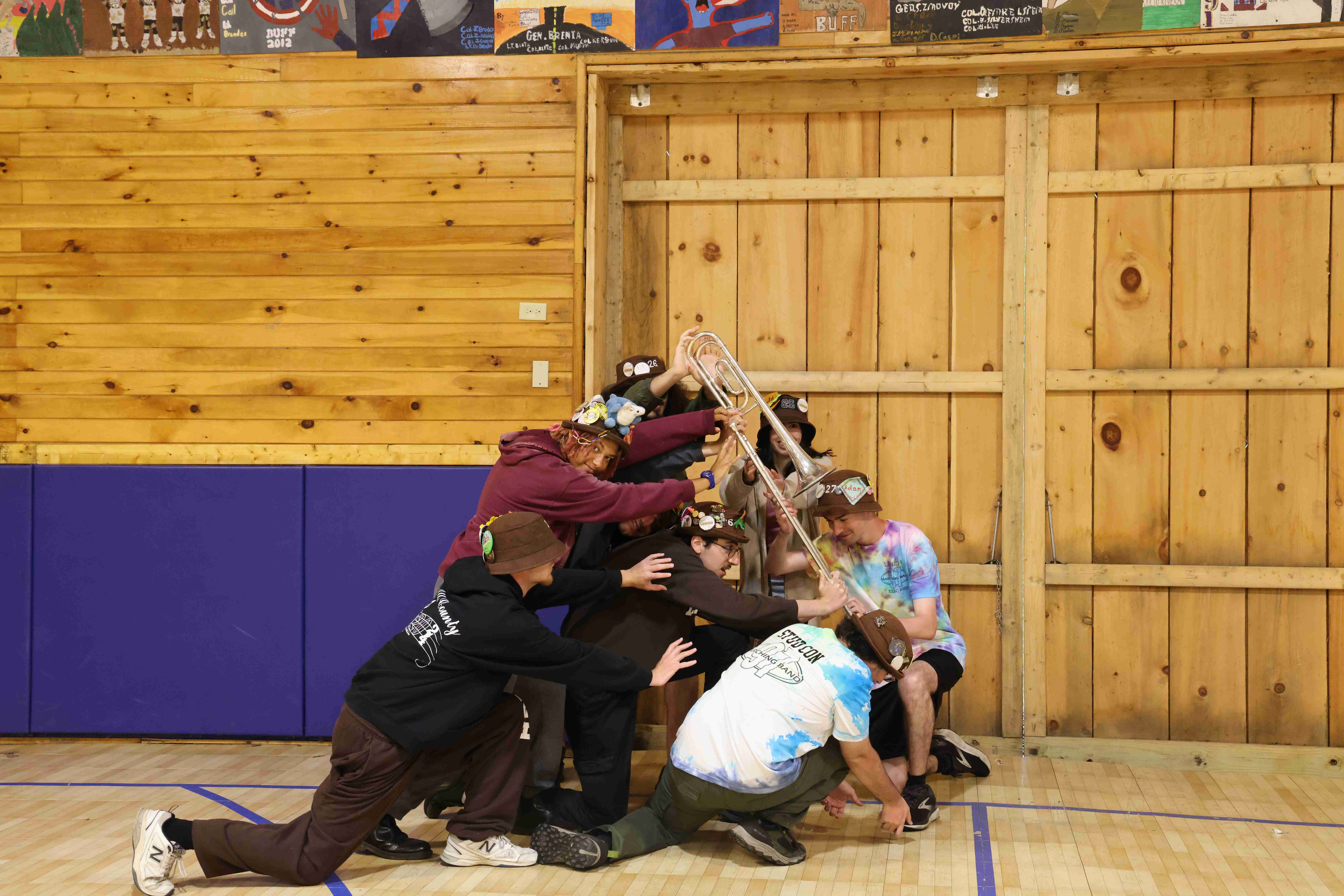 Rank 1 reenacting the famous 'Raising the Flag on Iwo Jima' photo with a trombone as the flagpole.