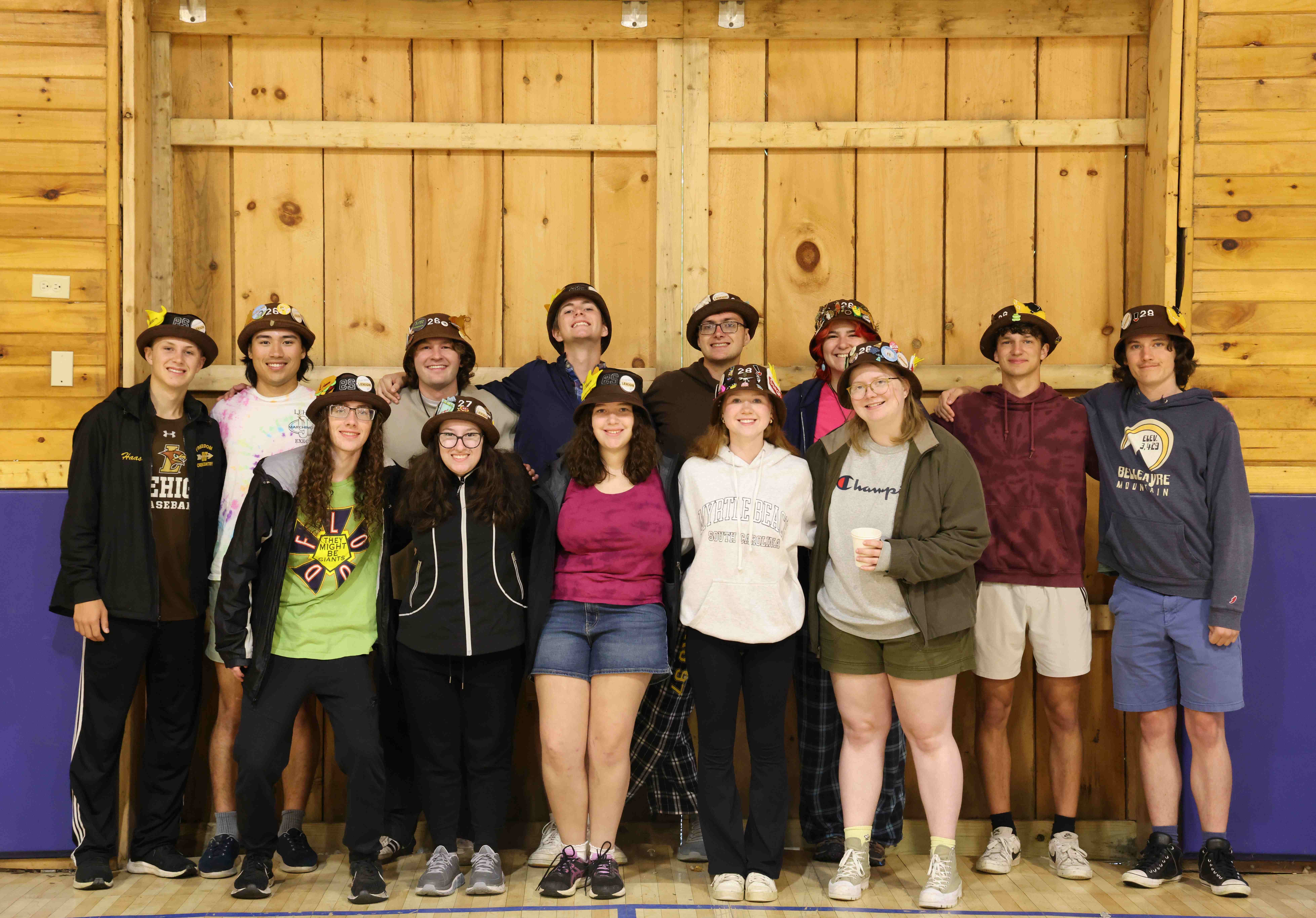 Ranks 3 and 12 in two rows, smiling with their arms around each other.