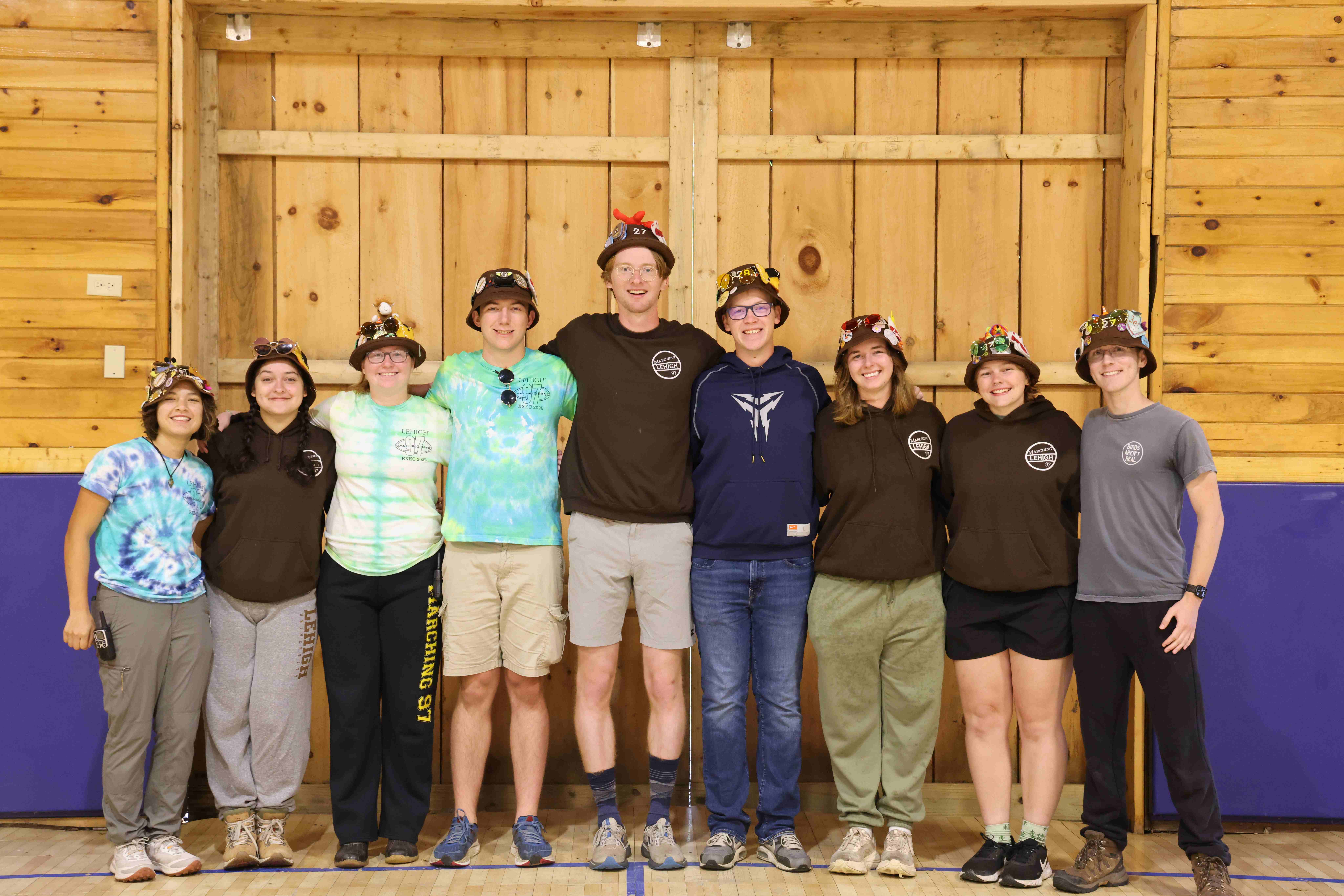 Rank 5 smiling with their arms around each other at band camp.