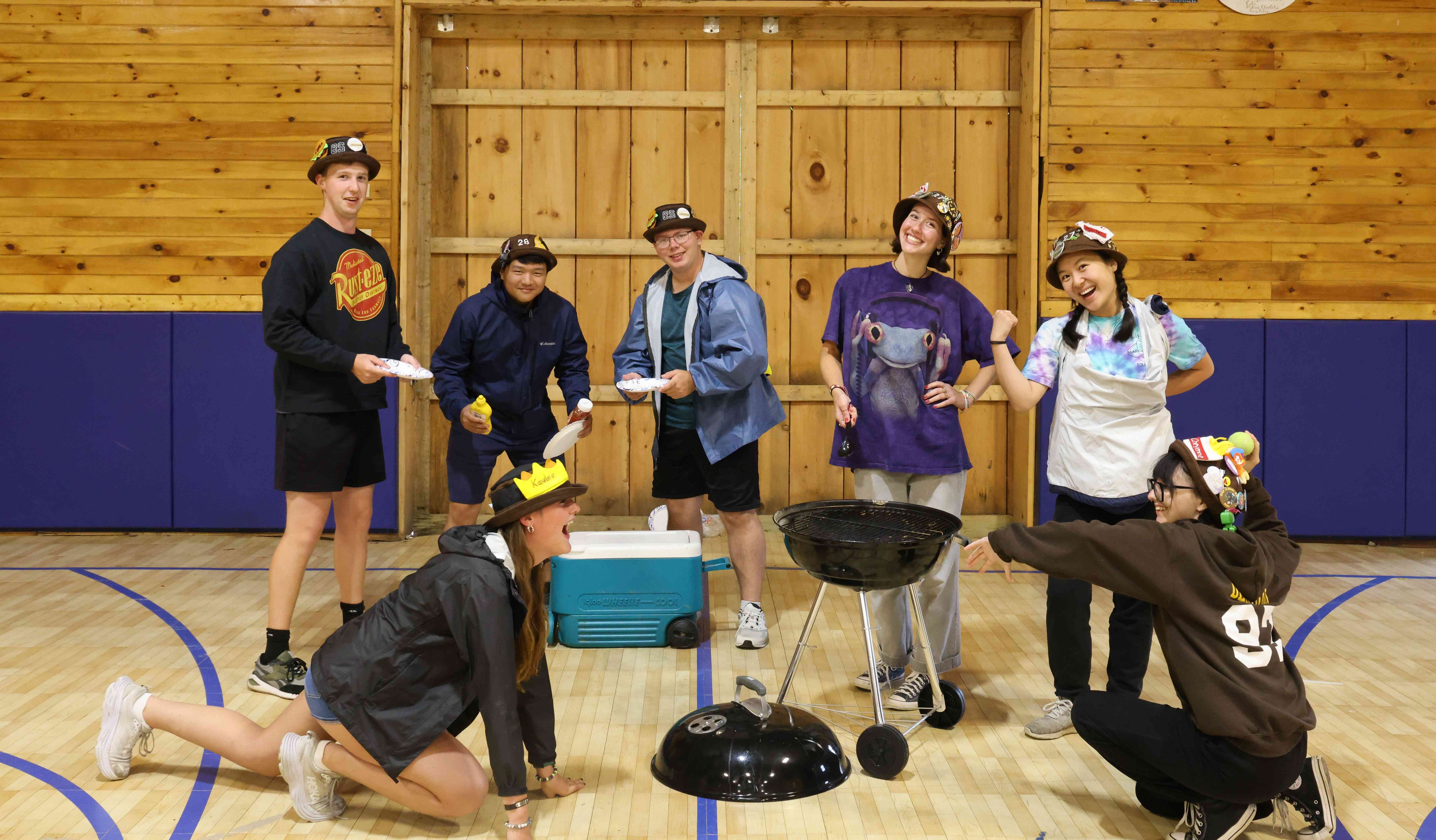 Rank 8 pretending to host a barbecue with 2 members grilling, 2 members playing fetch, and 3 members ready to eat.